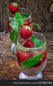 glass of refreshing strawberry cocktail. two glasses of alcoholic refreshing drink with mint and strawberries in vintage style.Selective focus.Photo tinted