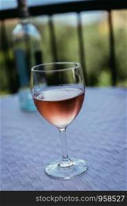 Glass of rose wine outdoors on the balcony. Evening scenery, Italy