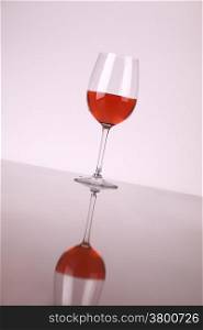 Glass of rose wine over a white background