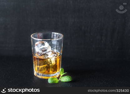 Glass of rum on the dark background