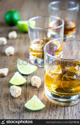 Glass of rum on the wooden background