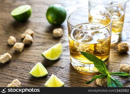 Glass of rum on the wooden background