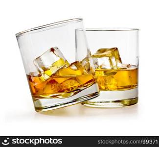 Glass of scotch whiskey and ice on a white background with clipping path