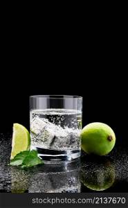 Glass of Soda or Coctail with steel cooling cubes on dark glass background.. Glass of Soda or Coctail with steel cooling cubes on dark glass background