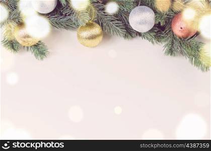 glass of sparkling wine and decorative christmas balls with fir tree on white surface, view from above