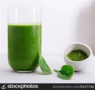 Glass of spinach detox juice isolated on white