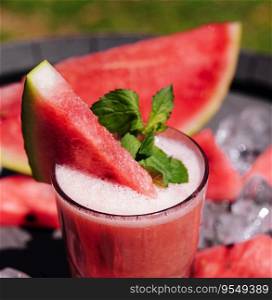 Glass of tasty refreshing drink with watermelon on ice
