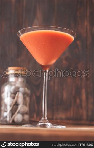 Glass of Trinidad Sour on wooden background