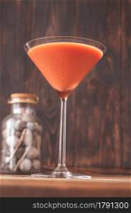 Glass of Trinidad Sour on wooden background