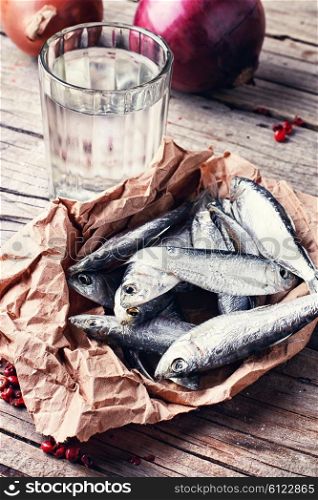 Glass of vodka,smoked sprat,spices in a rustic traditional Russian style