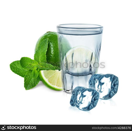 glass of vodka with lime, mint and ice cubes