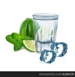 glass of vodka with lime, mint and ice cubes