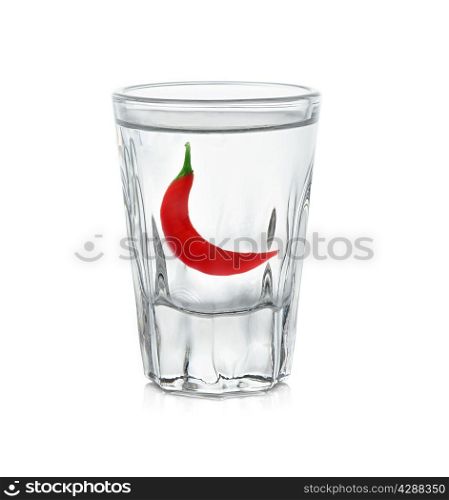 glass of vodka with red pepper isolated on white background
