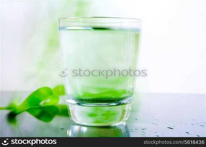 Glass of water and some abstract color
