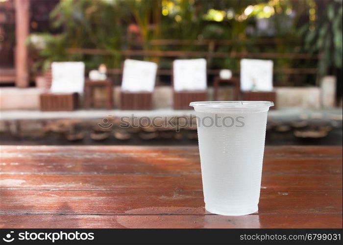 Glass of water on wooden table, stock photo