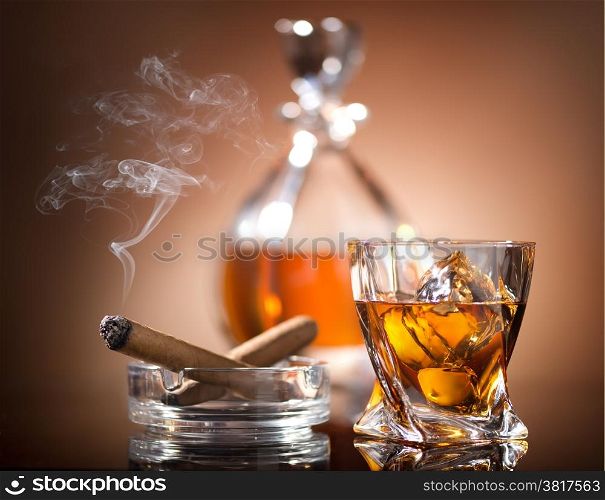 Glass of whiskey and a cigar in vintage style