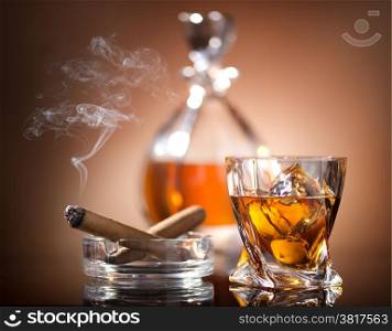 Glass of whiskey and a cigar in vintage style