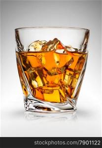 Glass of whiskey on a gray background