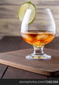 Glass of whiskey on wooden background. whiskey with ice on a wooden table