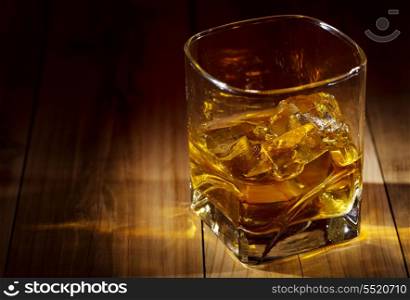 glass of whiskey on wooden table