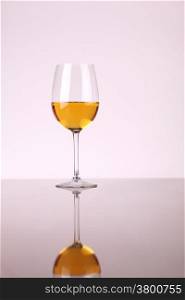 Glass of white wine over a white background