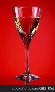 glass of white wine, red background