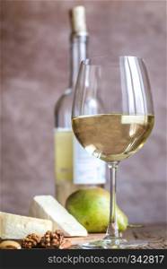Glass of white wine with cheese and nuts