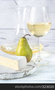 Glass of white wine with cheese and pears