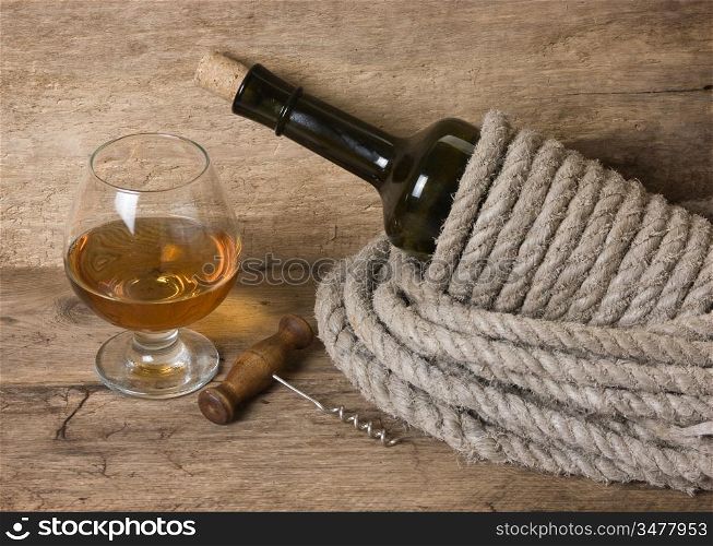 glass of wine and a bottle on the board