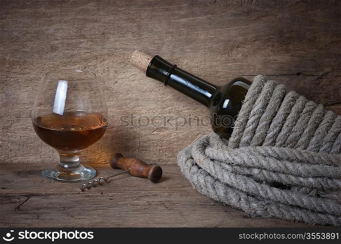 glass of wine and a bottle on the board