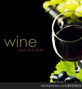 Glass of wine and grape on black background (easy removable sample text)