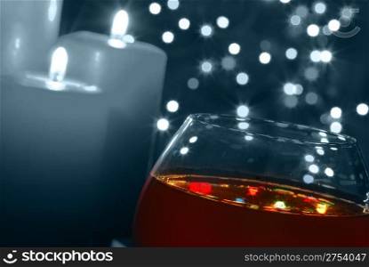 Glass of wine. On a background of celebratory fires, illumination by candles