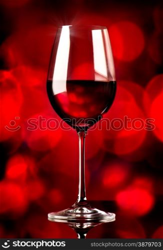 Glass of wine on a red background