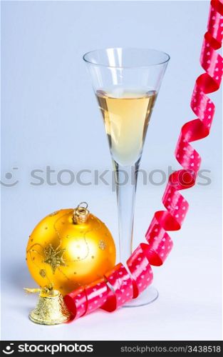 glass of wine with a ribbon and New Year&acute;s ball