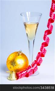 glass of wine with a ribbon and New Year&acute;s ball