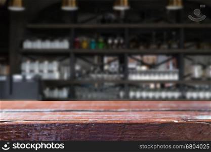 glass on counter bar in restaurant interior blur background with selected focus empty wood table for display or montage your product