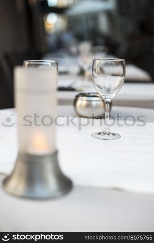 Glass on table in a restaurant. White tablecloth