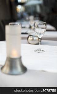 Glass on table in a restaurant. White tablecloth