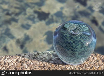 Glass or Crystal blue apple and reflective surface on blue water background. Copy space, Selective focus.