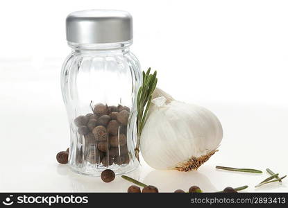 Glass pepper shakers with garlic and rosemary