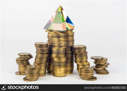 Glass pyramid on high stacks of coins