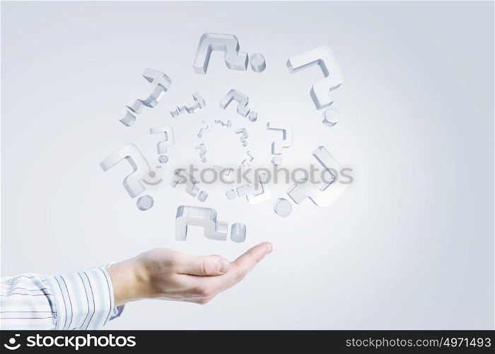 Glass question marks. Close up of businessman hand holding glass question symbols