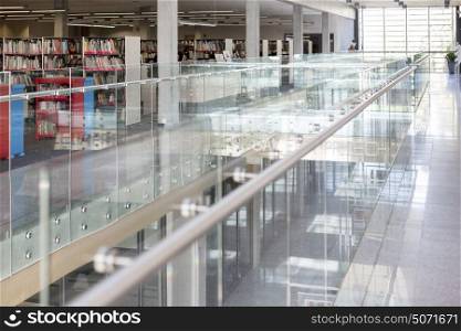 Glass railing at corridor by library in modern university