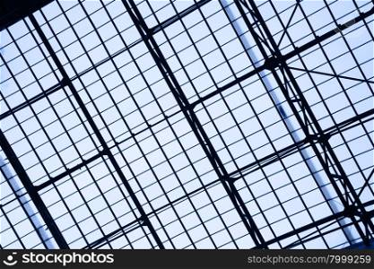 Glass roof of industrial building toned in blue color