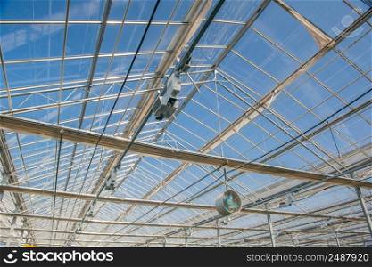glass roof with fan in modern greenhouse. the roof in the greenhouse