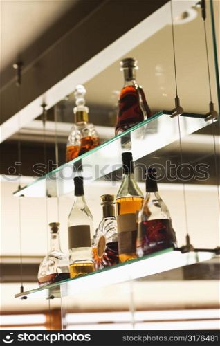 Glass shelves with liquor bottles.