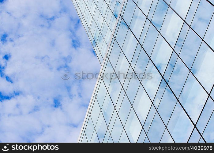 Glass skyscraper and cloudy sky