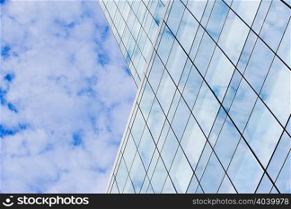 Glass skyscraper and cloudy sky