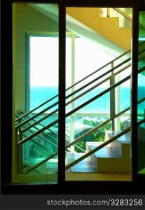 Glass stairwell with windows looking out onto ocean