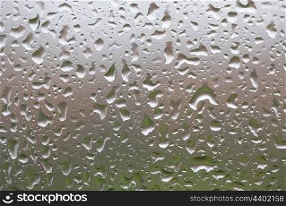 Glass surface with water drops in a rainy day